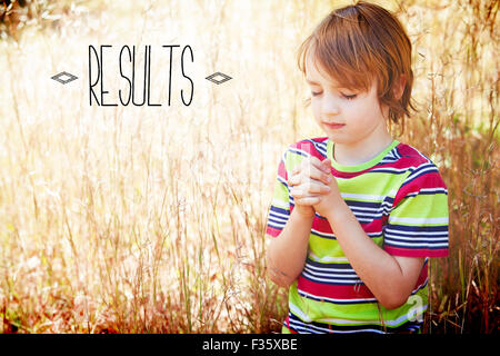 Results against praying little boy in the park Stock Photo