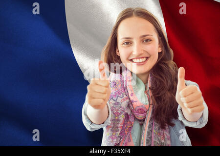 Composite image of woman showing thumbs up Stock Photo