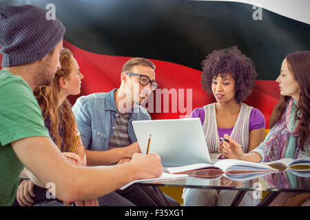 Composite image of fashion students working as a team Stock Photo