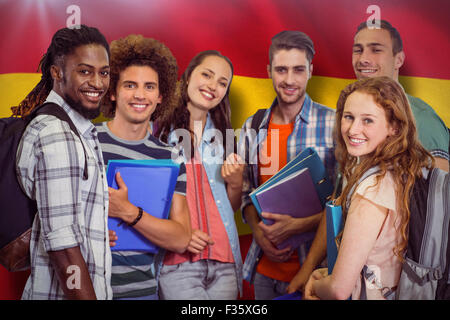 Composite image of smiling group of students holding folders Stock Photo