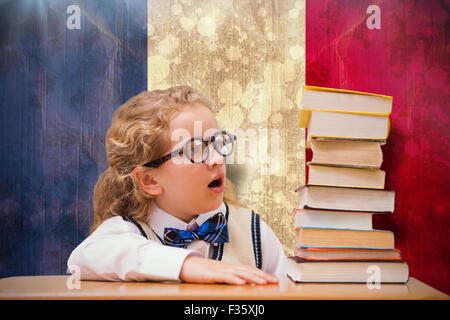 Composite image of surprise pupil looking at books Stock Photo