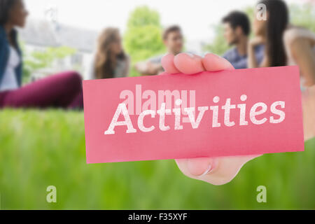 Activities against happy students sitting outside on campus Stock Photo