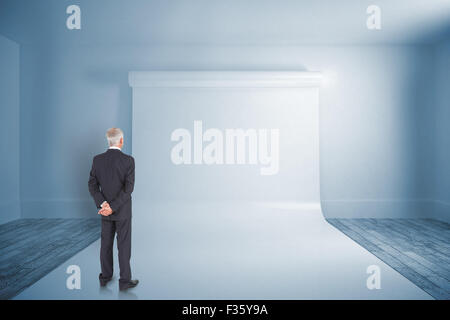 Composite image of rear view of mature businessman posing Stock Photo