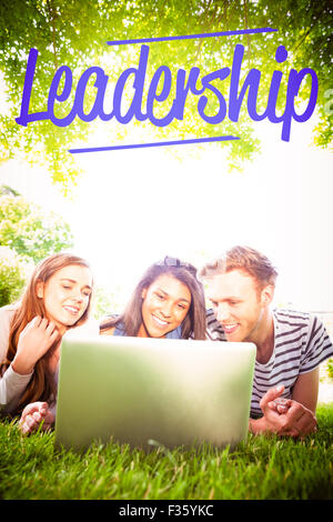 Happy students using laptop outside Stock Photo - Alamy