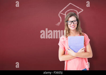 Composite image of pretty geeky hipster holding notepad Stock Photo