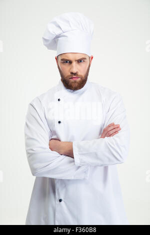 Portrait of angry male chef cook standing with arms folded isolated on a white background Stock Photo