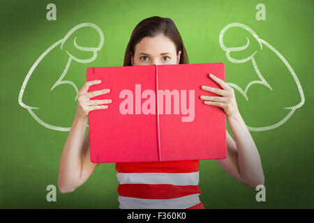 Composite image of student holding book over face Stock Photo