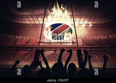 Composite image of silhouettes of football supporters Stock Photo
