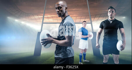 Composite image of rugby player holding rugby ball Stock Photo