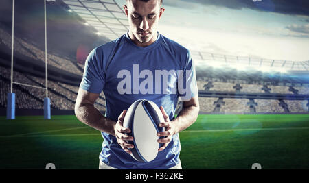 Composite image of rugby player holding ball Stock Photo