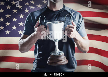 Composite image of victorious rugby player holding trophy Stock Photo