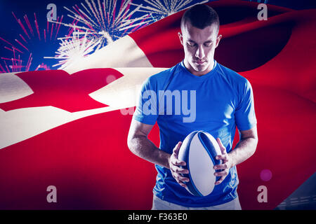 Composite image of rugby player holding ball Stock Photo