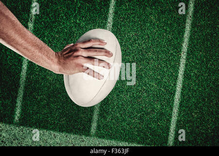 Composite image of cropped image of sports player holding ball Stock Photo