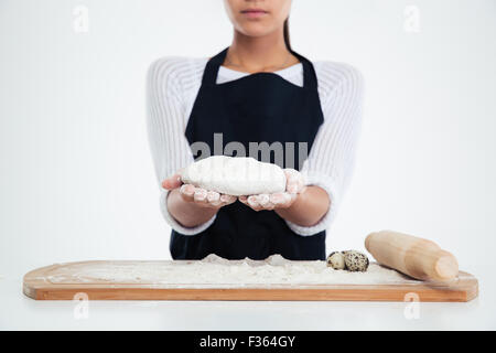 Closeup portrait of a female hands preparing dough for pastry isolated on a white background Stock Photo