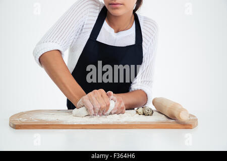 Closeup portrait of a female hands preparing dough for pastry isolated on a white background Stock Photo
