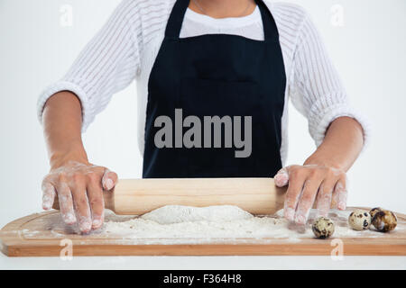 Closeup portrait of a female hands working on unfinished dough with a rolling pin Stock Photo