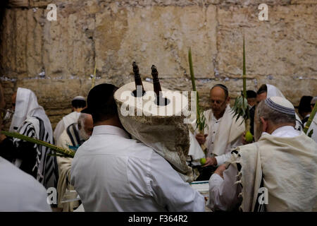 Jerusalem, Israel. 30th September, 2015. Ultra-Orthodox Jewish worshipers attend the annual Cohanim prayer priest's blessing during Sukkot or the feast of the Tabernacles, holiday at the Western Wall in the old city of Jerusalem on September 30 2015. Tens of thousands of Jews make the week-long pilgrimage to Jerusalem during Sukkot, which commemorates the desert wanderings of Israel after their exodus from Egypt. Credit:  Eddie Gerald/Alamy Live News Stock Photo