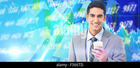 Composite image of businessman using mobile phone with colleagues behind Stock Photo