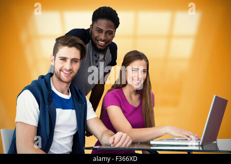 Composite image of creative team using laptop Stock Photo