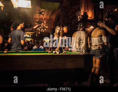 A transgender woman plays pool in a bar on Khao San Road, Bangkok. Stock Photo
