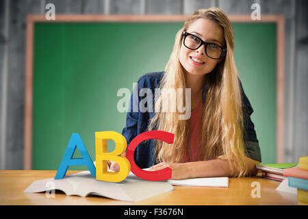 Composite image of student studying in the library Stock Photo