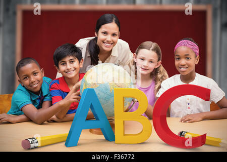 Composite image of cute pupils and teacher looking at globe in library Stock Photo