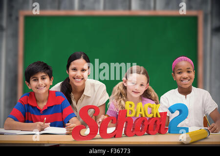 Composite image of pretty teacher helping pupils in library Stock Photo