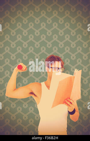 Composite image of geeky hipster lifting dumbbells and reading notepad Stock Photo