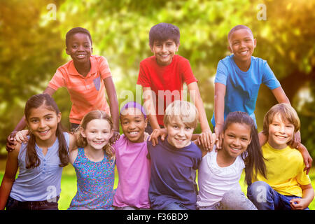 Composite image of happy friends in the park Stock Photo