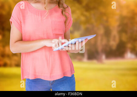 Composite image of hipster woman holding tablet pc Stock Photo