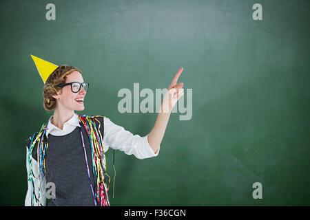 Composite image of happy geeky hipster pointing something Stock Photo