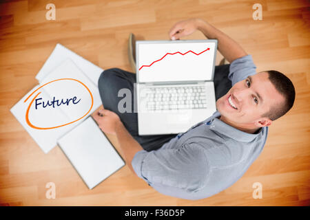 Future against young creative businessman working on laptop Stock Photo