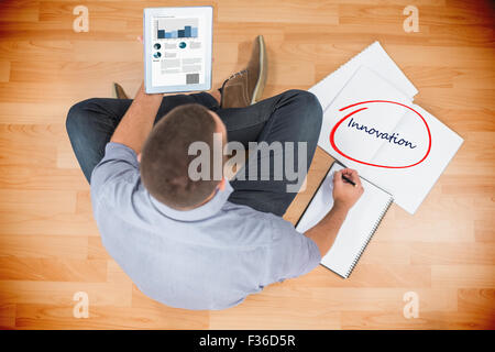 Innovation  against young creative businessman looking at tablet Stock Photo