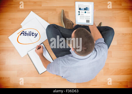 Ability  against young creative businessman looking at tablet Stock Photo