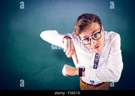 Composite image of geeky businessman pointing to watch Stock Photo