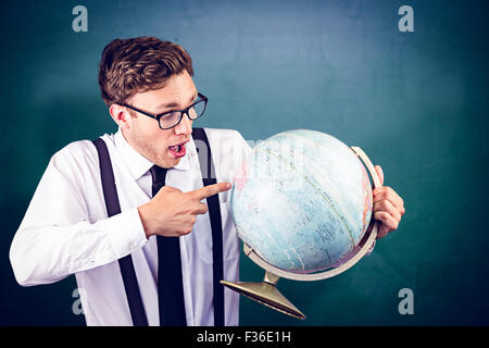 Composite image of geeky businessman pointing to globe Stock Photo