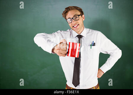 Composite image of young geeky businessman holding mug Stock Photo