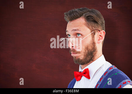 Composite image of geeky hipster wearing christmas vest Stock Photo