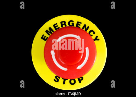 A big red emergency stop button against a black background Stock Photo