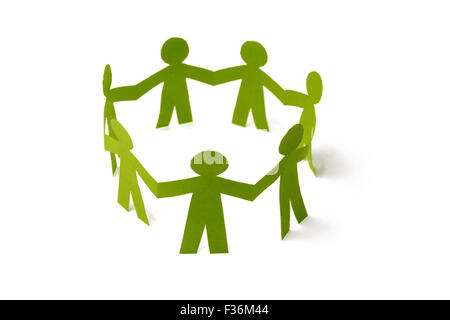 Group of paper doll holding hands. Stock Photo