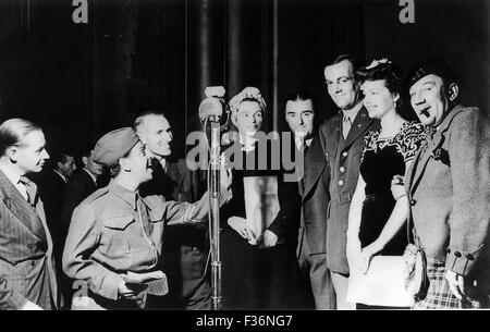 GLENN MILLER (1904-1944) US big band leader in his US Army Air Force uniform rehearsing for radio show Variety Bandbox on 30 July 1944. He stands next to actress Margaret Lockwood who was also announcer on the programme. The other woman is singer Bertha Williams. Stock Photo