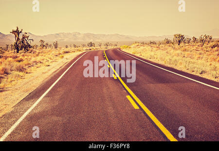 Retro old film style endless country highway, travel adventure concept, Joshua Tree National Park, USA.