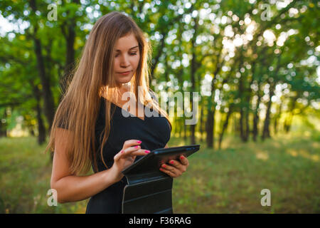 a woman of European appearance twenty years holding a tablet in Stock Photo