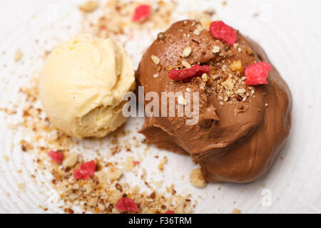 Vanilla and Chocolate Ice cream with rose petals and roasted hazelnut Stock Photo