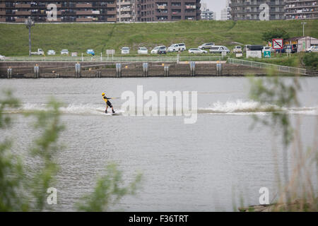 Man on waterski holding onto line park in the background Stock Photo