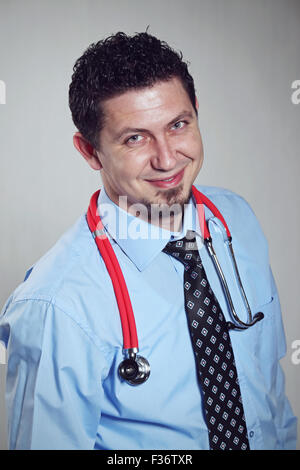 Portrait of handsome young male doctor smiling. Stock Photo