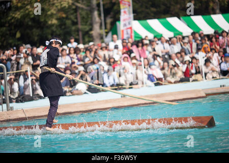 traditional Japanese yukata balancing on square log on water Stock Photo