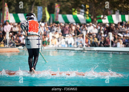 traditional Japanese yukata balancing on square log on water Stock Photo