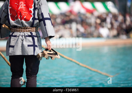 traditional Japanese yukata balancing on square log on water Stock Photo