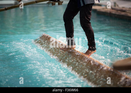 traditional Japanese yukata balancing on square log on water Stock Photo